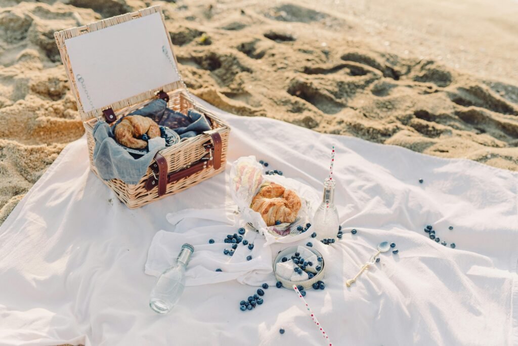 pexels-photo-8908607-8908607 A serene beach picnic with fresh croissants and blueberries.